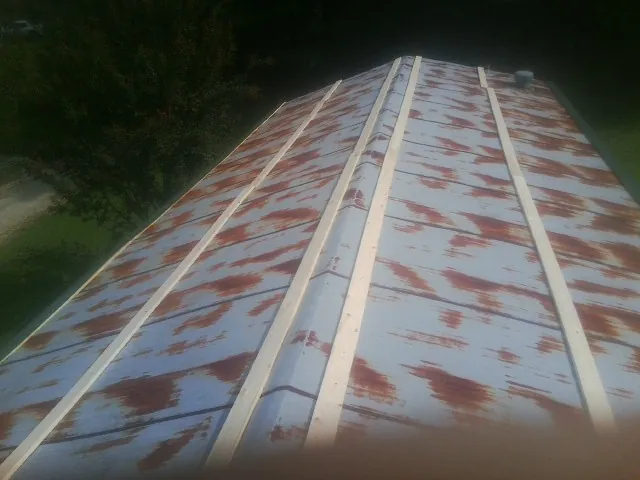 Rusted metal roof panels with new wood purlins before replacement — Storm Damage Roof Repair in Vanleer by Roofing Brothers